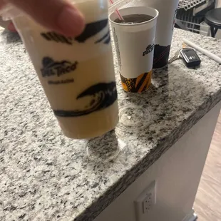 a hand holding a cup of coffee