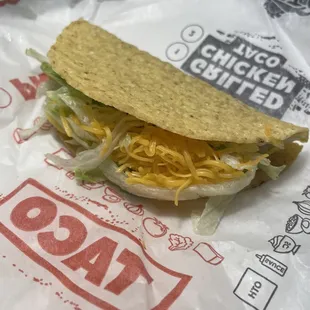 a taco sandwich with cheese and lettuce