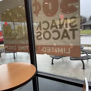 a sign in a window that says snack tacos limited time only
