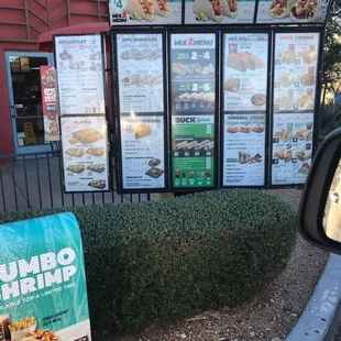 a menu and a sign in front of a restaurant