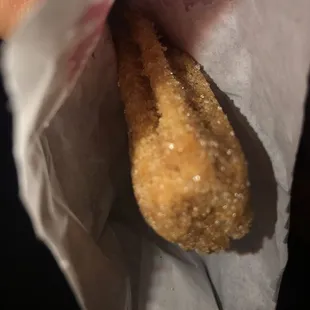 a hand holding a piece of food