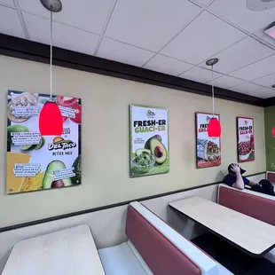 a woman sitting at a table in a restaurant