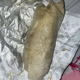 a burrito wrapped in aluminum foil
