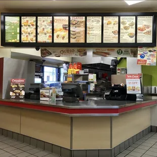 the counter and menus of a restaurant