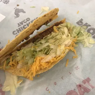 a taco sandwich with lettuce and cheese