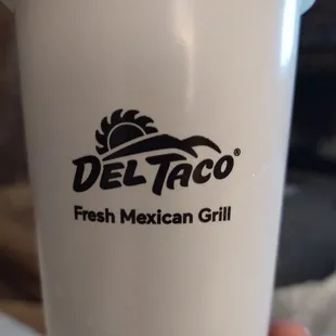 a hand holding a cup of fresh mexican grill