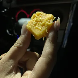 a person holding a piece of food