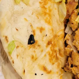 A big piece of burnt char, I bit inside my Taco.