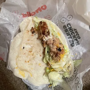 This is one of my chicken soft tacos. Burned chicken no cheese and lettuce out at the bottom? So gross