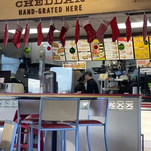 a restaurant with a counter and chairs