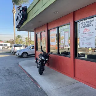 a motorcycle parked in front of a restaurant