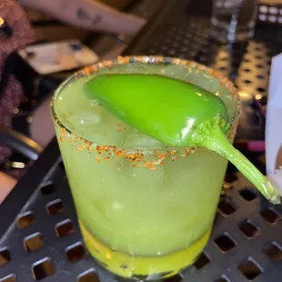 a margarita with a green spoon in it