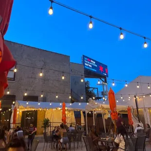 a patio area with tables and umbrellas