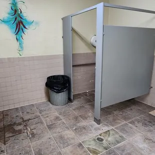 a public restroom with urinals and sinks