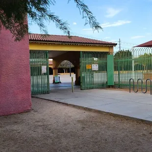 a colorful building with a green gate