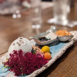 a platter of food on a wooden table