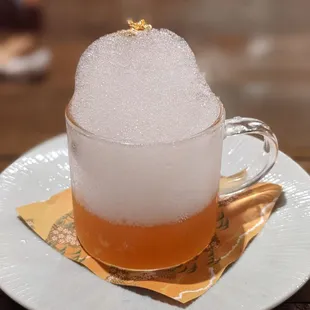 a glass of beer on a plate