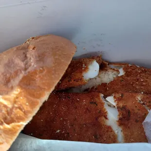 a hand holding a sandwich