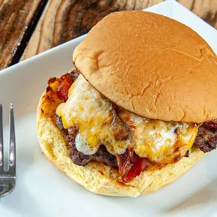 a cheeseburger on a plate with a fork