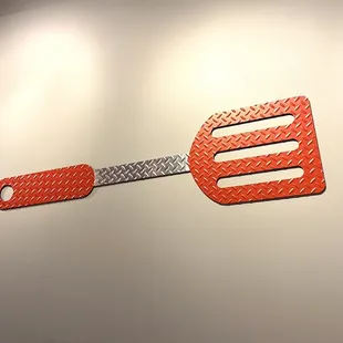 Huge spatula on wall