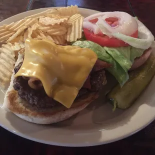 a hamburger with cheese and pickles