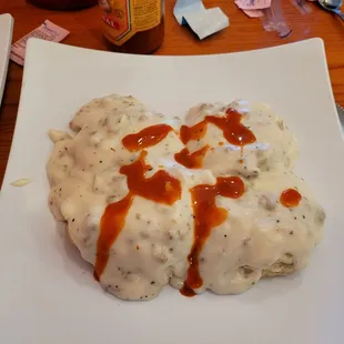 Sausage gravy and biscuit (full order). Hot sauce not included. Lol. Put hot sauce on before I remembered to take picture.