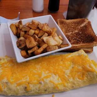 Veggie omelet and added ham &amp; sausage. Paid extra for country potatoes.