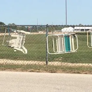 Chairs cabled and locked  to the fence to "save their spot" for THE LITTLE BROWN JUG !