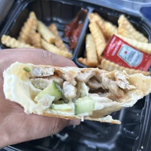 Chicken Shawarma inside - seasoned chicken, garlic sauce, pickles &amp; cucumbers. Was a big portion, not authentic but not bad.