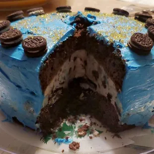 a blue frosted cake with oreo cookies