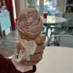 Black cherry ice cream in a waffle cone