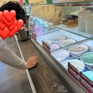 a woman looking at a display case