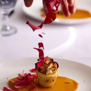 Frozen rose petals falling over dessert.