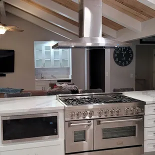 a kitchen with a christmas tree in the background