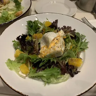 Some sort of salad with a poached egg or something on top.  Looks like a Woz order to me.