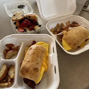 Ciabatta Breakfast Sandwich with breakfast potatoes and fruit yogurt.
