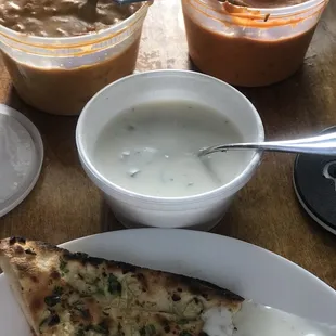 Take out. Butter chicken, chicken tikka masala garlic naan and Raita