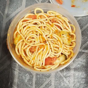 a plate of spaghetti and a plate of chicken