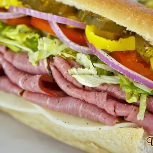 a sub sandwich with meat and vegetables