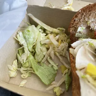 a sandwich and salad in a box