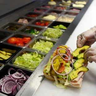 a person preparing a sandwich