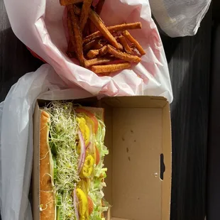 Vegetarian sandwich on Dutch bread with sweet potatoes fries.