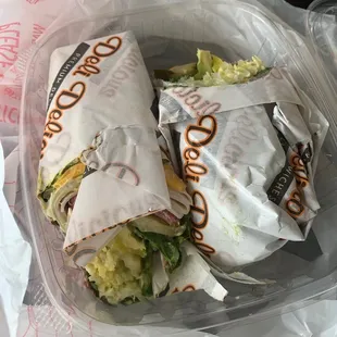 a sandwich wrapped in plastic wrap