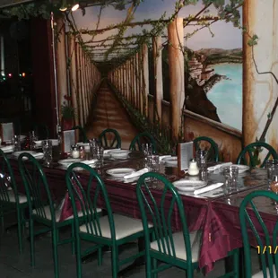 a long dining table set with place settings
