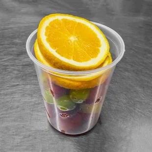 a plastic cup filled with fruit