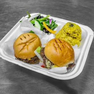 a sandwich and side salad in a styrofoam container