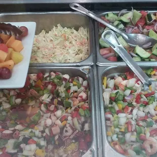 Ceviches, fruit salad, slaw, and cucumber salad