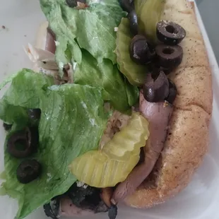 a sub sandwich with lettuce and olives
