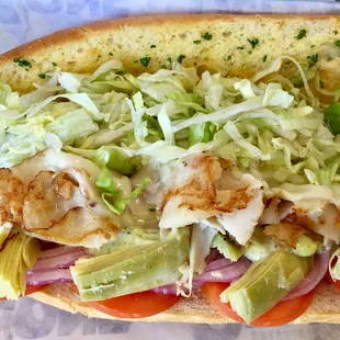 Manhattan - Pesto Mayo, Turkey, Tomato, Red Onion, Artichokes, Provolone Cheese, and Garlic Spread