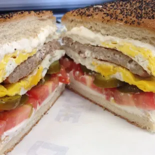 The DiMaggio breakfast sandwich come Italian Sausage, fried Eggs, Cream cheese, Tomato and Jalapenos served on a Poppy seeds kaiser roll.